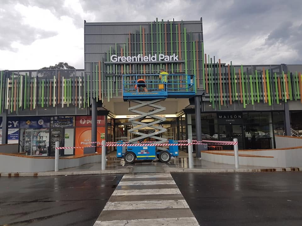 Fascia letters being installed from a scissor lift at Greenfield Park Shopping Village